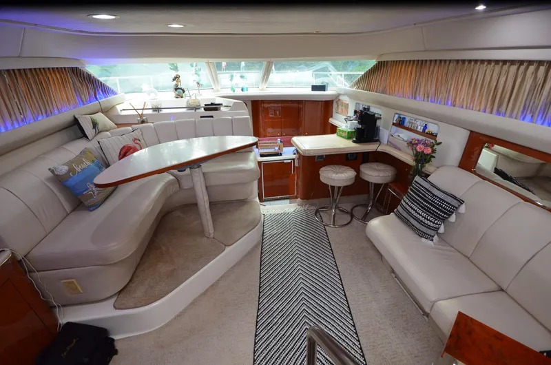 Slide: The Image of Luxurious interior of 2000 Sea Ray 420 Aft Cabin yacht with plush seating and modern decor. - 21
