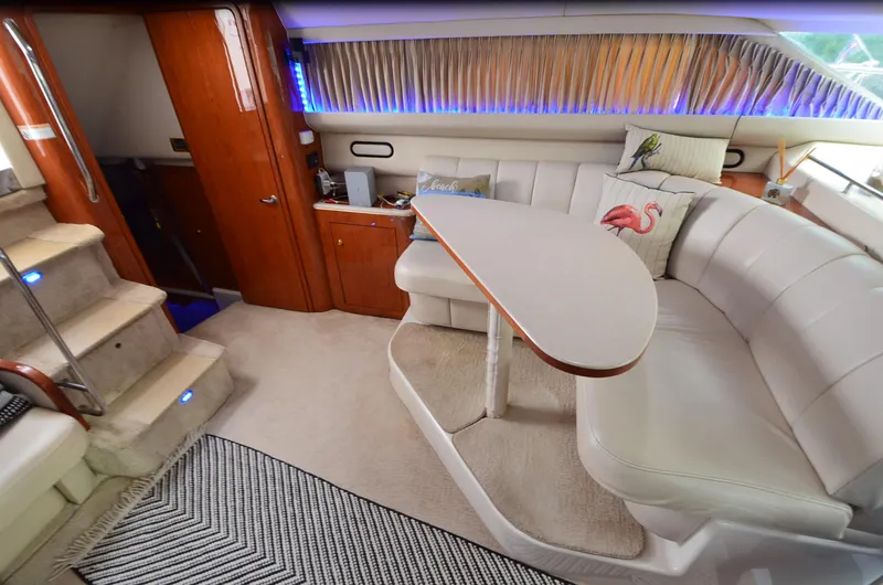 Slide: The Image of Luxurious interior of 2000 Sea Ray 420 Aft Cabin yacht with plush seating and elegant decor. - 24