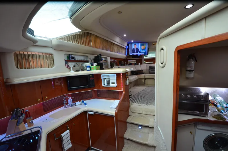 Slide: The Image of Luxurious interior of 2000 Sea Ray 420 Aft Cabin yacht with modern kitchen and living area. - 25