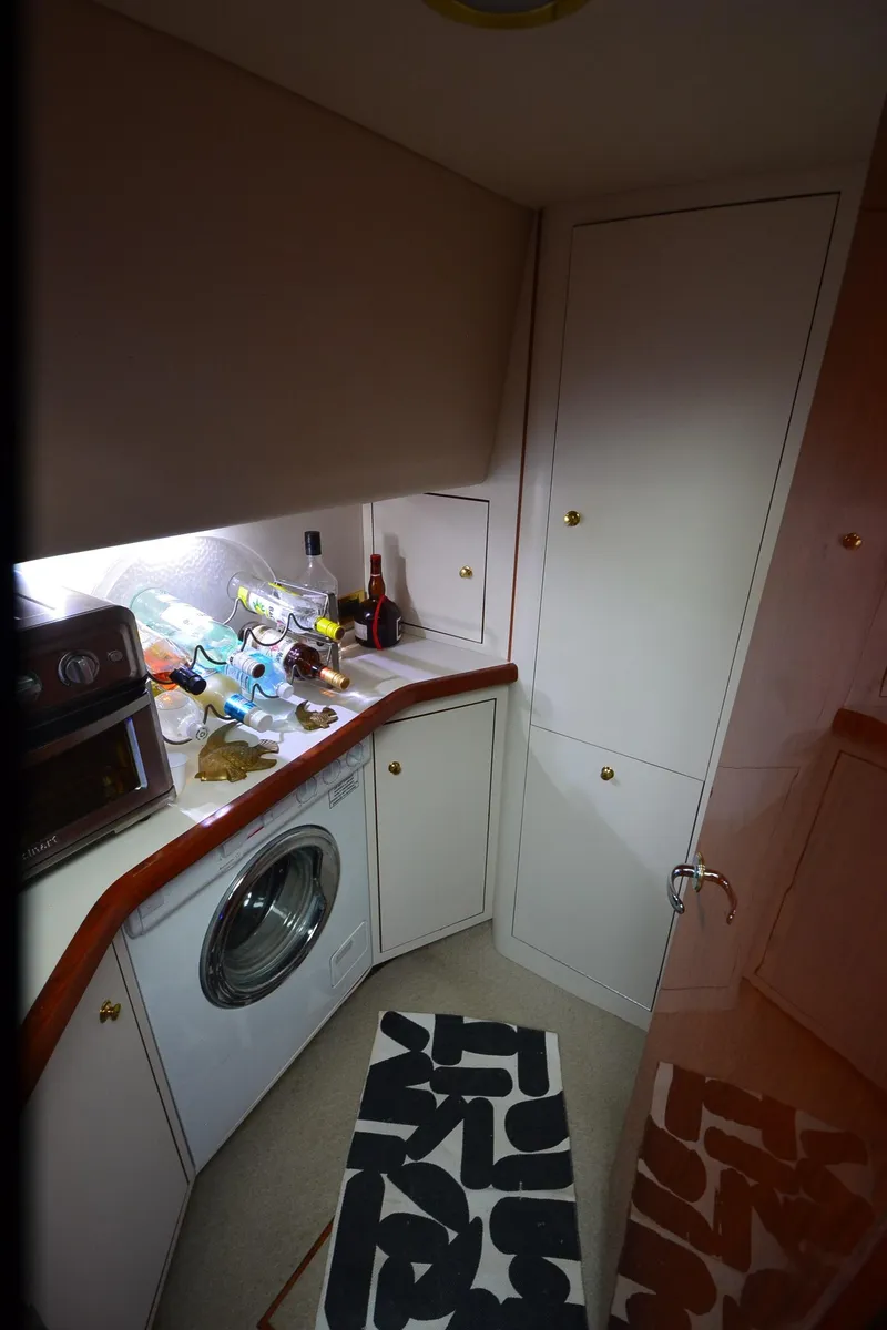 Slide: The Image of Laundry area in 2000 Sea Ray 420 Aft Cabin with washer and storage cabinets. - 30