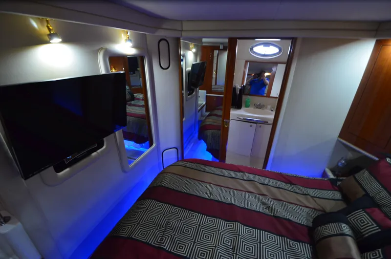 Slide: The Image of Luxurious interior of 2000 Sea Ray 420 Aft Cabin with modern amenities and ambient lighting. - 31