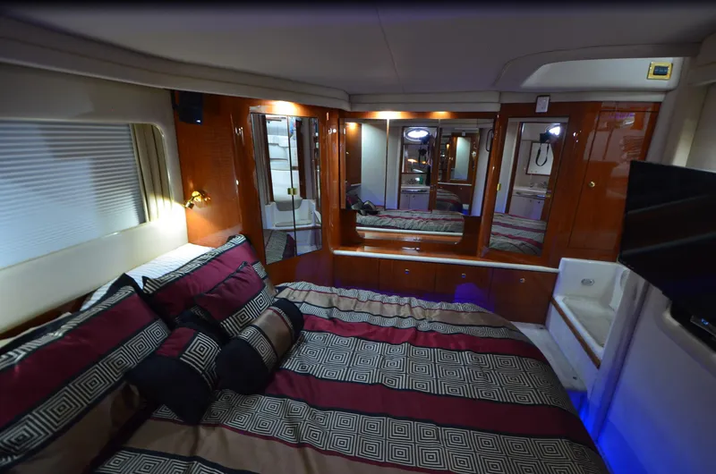 Slide: The Image of Luxurious cabin interior of 2000 Sea Ray 420 Aft Cabin yacht with elegant bedding. - 32