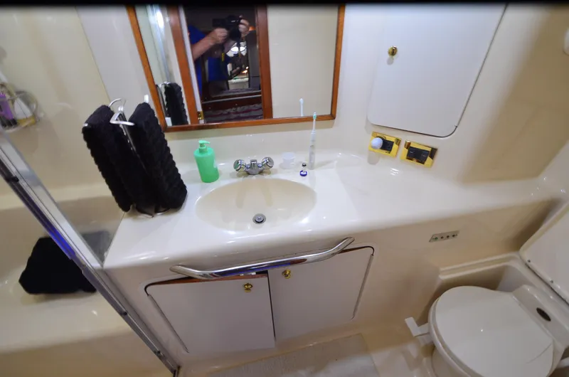 Slide: The Image of Bathroom interior of 2000 Sea Ray 420 Aft Cabin yacht, featuring sink and toilet. - 35