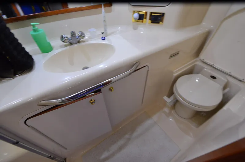 Slide: The Image of Bathroom interior of 2000 Sea Ray 420 Aft Cabin yacht, featuring sink and toilet. - 36
