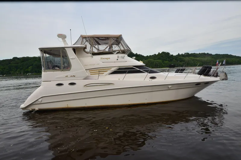 Slide: The Image of 2000 Sea Ray 420 Aft Cabin yacht on calm water, side view. - 37