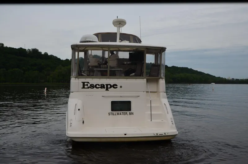 Slide: The Image of Sea Ray 420 Aft Cabin boat named "Escape" on a calm lake, 2000 model. - 39