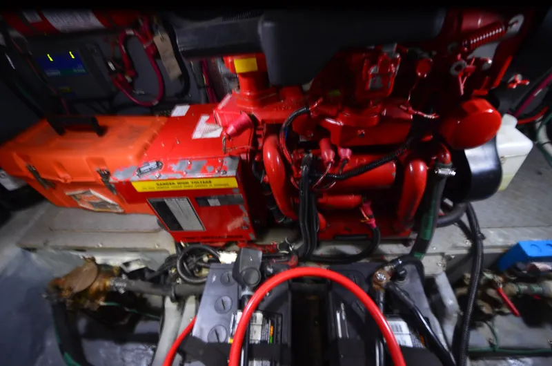 Slide: The Image of Engine room of 2000 Sea Ray 420 Aft Cabin with red machinery and wiring. - 43