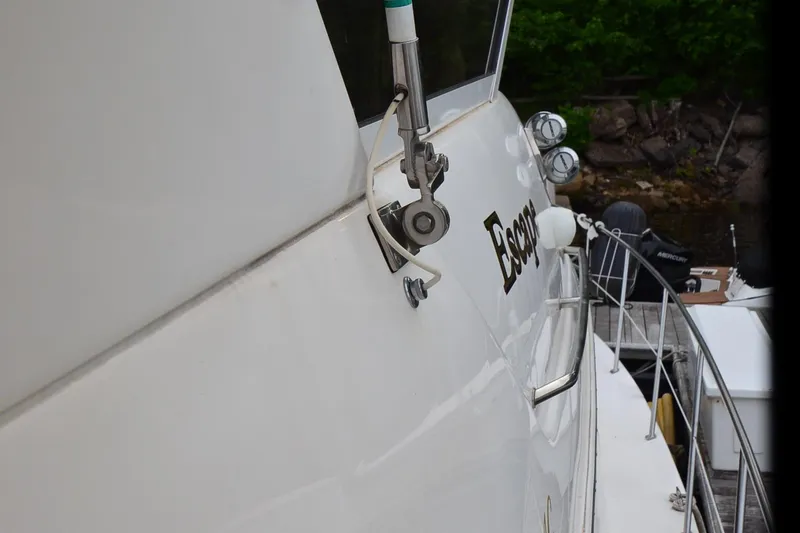 Slide: The Image of 2000 Sea Ray 420 Aft Cabin yacht docked, showing side view and railing details. - 48