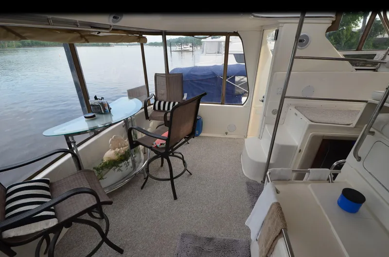Slide: The Image of Interior of 2000 Sea Ray 420 Aft Cabin yacht with seating and table by the water. - 5
