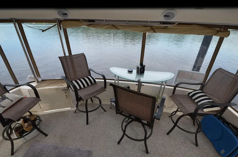 Slide: The Image of Aft deck of 2000 Sea Ray 420 Aft Cabin with chairs and table overlooking water. - 6