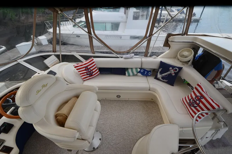 Slide: The Image of Luxurious 2000 Sea Ray 420 Aft Cabin interior with nautical-themed cushions and plush seating. - 9