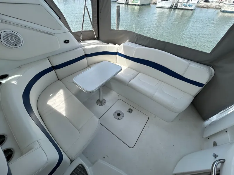 Slide: The Image of 2005 Formula 37 PC yacht interior with white seating and table, docked by the water. - 15