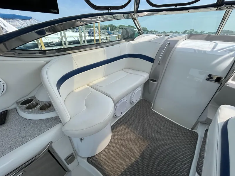 Slide: The Image of 2005 Formula 37 PC boat interior with white seating and cup holders. - 16