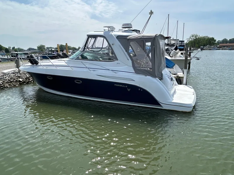 Slide: The Image of 2005 Formula 37 PC boat docked in a marina, side view. - 2