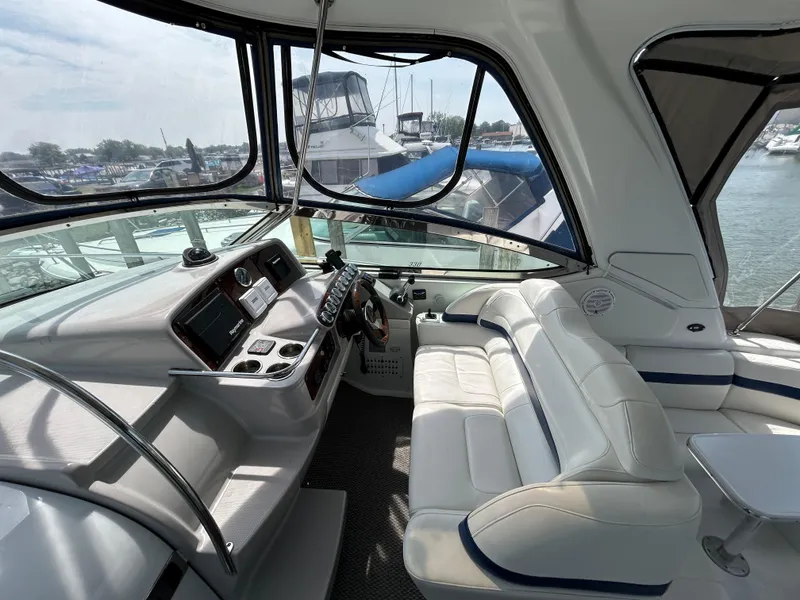 Slide: The Image of Interior of a 2005 Formula 37 PC yacht with white seating and control panel. - 21