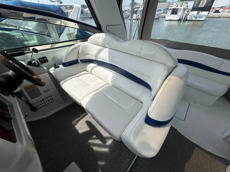 Slide: The Image of 2005 Formula 37 PC yacht interior with white seating and marina view. - 22