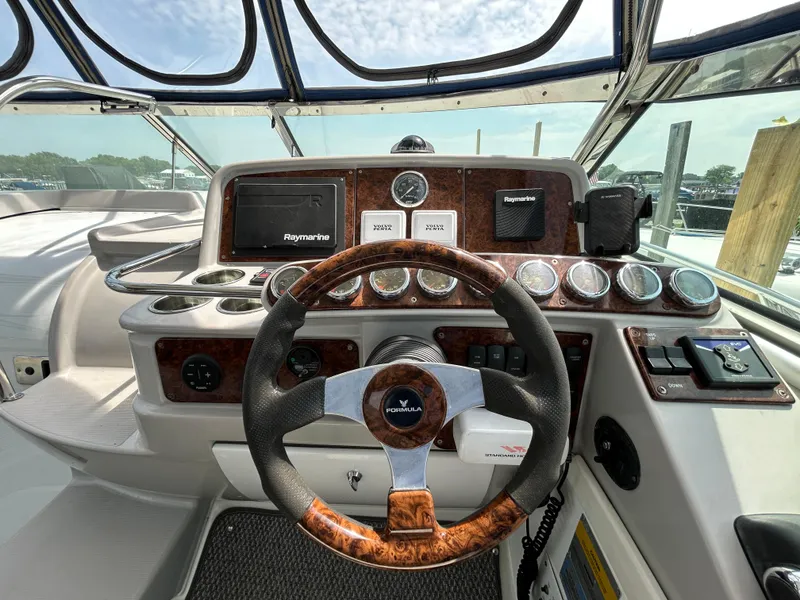 Slide: The Image of 2005 Formula 37 PC yacht dashboard with steering wheel and navigation instruments. - 23
