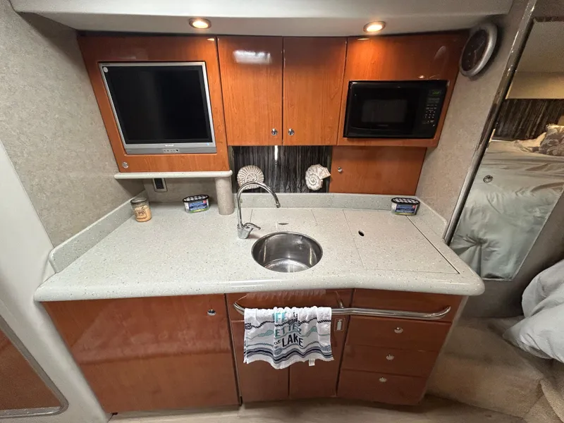 Slide: The Image of 2005 Formula 37 PC yacht kitchen with TV, microwave, and sink. - 37
