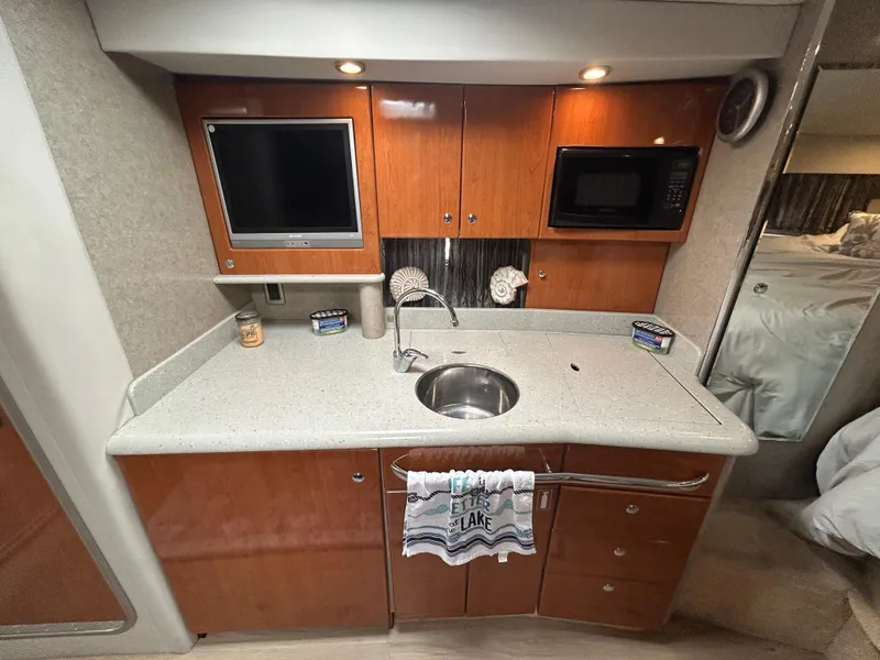Slide: The Image of 2005 Formula 37 PC yacht kitchen with sink, microwave, and TV. - 42