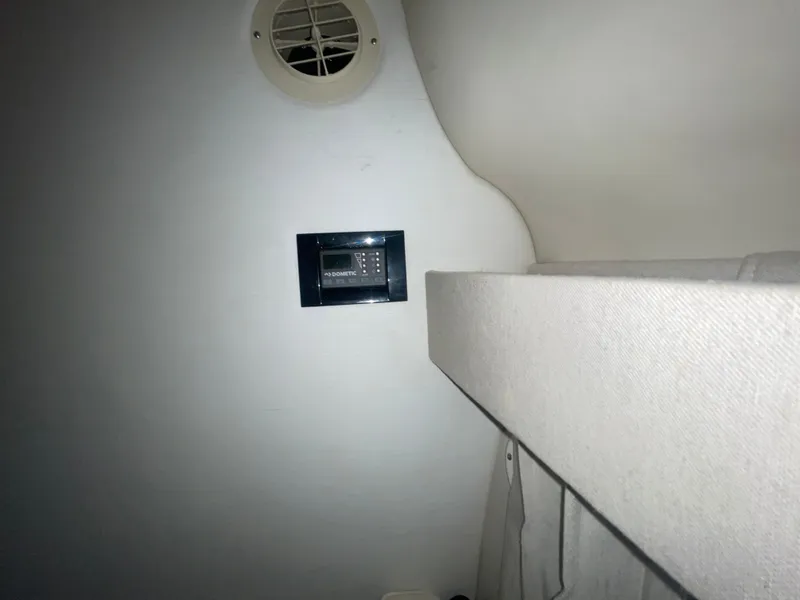 Slide: The Image of Interior of 2019 Regal 28 Express boat with Dometic control panel and vent. - 11