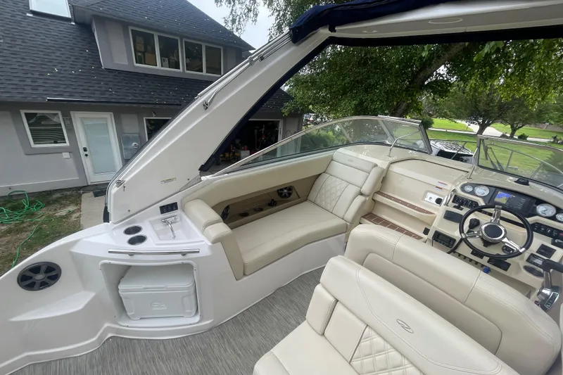 Slide: The Image of 2019 Regal 28 Express boat interior with beige seating and modern dashboard. - 16