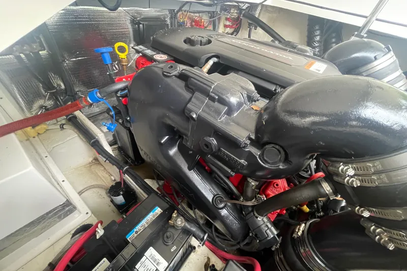 Slide: The Image of Engine compartment of a 2019 Regal 28 Express boat, showcasing detailed components. - 32