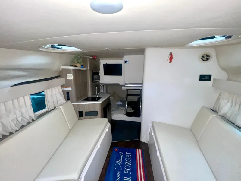 Slide: The Image of Interior of 2019 Regal 28 Express boat with seating, kitchenette, and decor. - 5