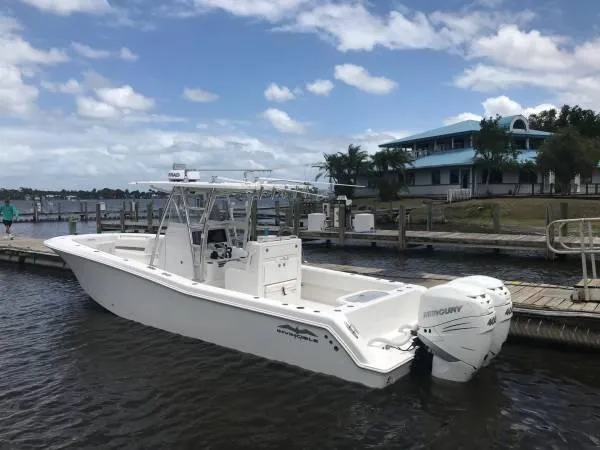 The Image of 2020 Invincible 33 Open Fisherman boat docked by a scenic waterfront. - 0