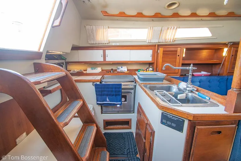 Slide: The Image of Interior of 1988 Catalina 36 sailboat kitchen with wooden cabinetry and stainless steel sink. - 20