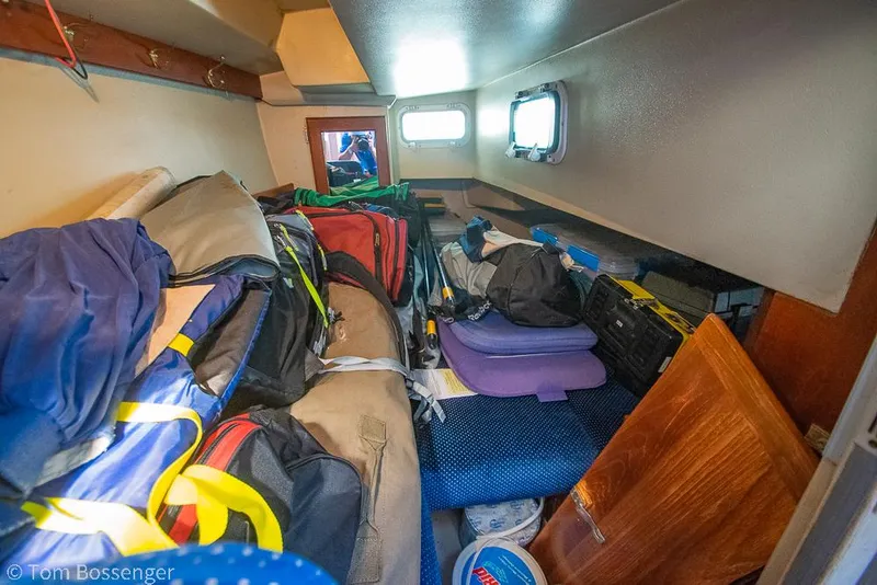 Slide: The Image of Cabin interior of 1988 Catalina 36 sailboat, cluttered with bags and equipment. - 26