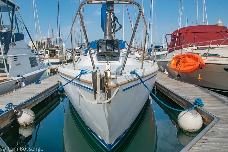 Slide: The Image of 1988 Catalina 36 sailboat docked at marina, surrounded by other boats. - 3