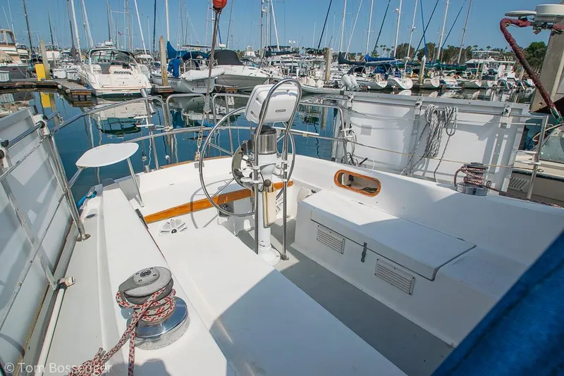 Slide: The Image of Cockpit of 1988 Catalina 36 sailboat docked in a marina, surrounded by other boats. - 34