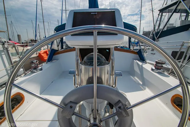 Slide: The Image of Steering wheel of a 1988 Catalina 36 sailboat in a marina setting. - 35