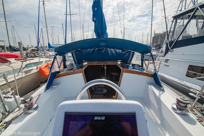 Slide: The Image of Cockpit view of a 1988 Catalina 36 sailboat docked in a marina. - 37