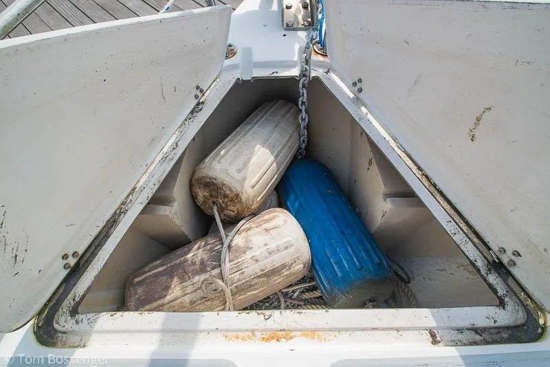 Slide: The Image of Open storage compartment on 1988 Catalina 36 sailboat with fenders and chain. - 46