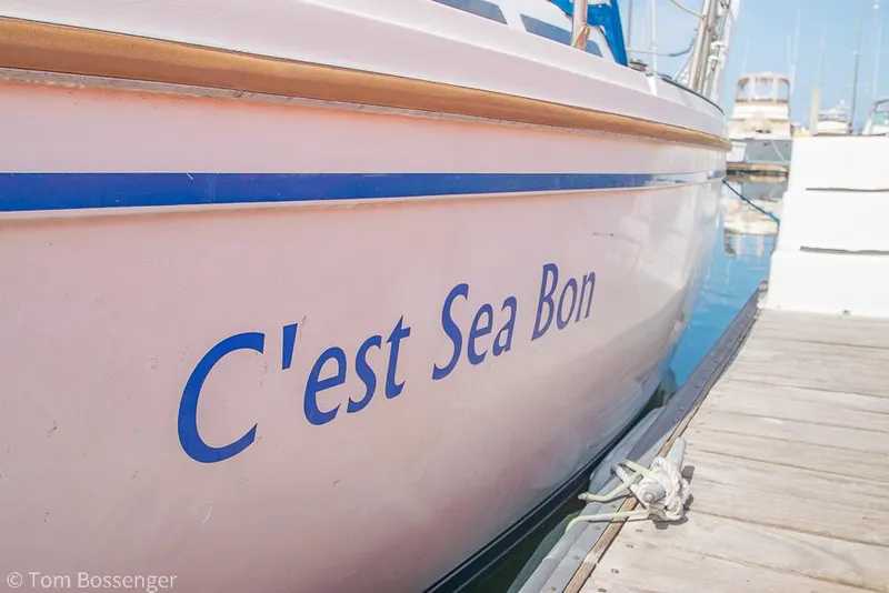 Slide: The Image of Catalina 36 sailboat named "C'est Sea Bon" docked at a marina, 1988 model. - 5