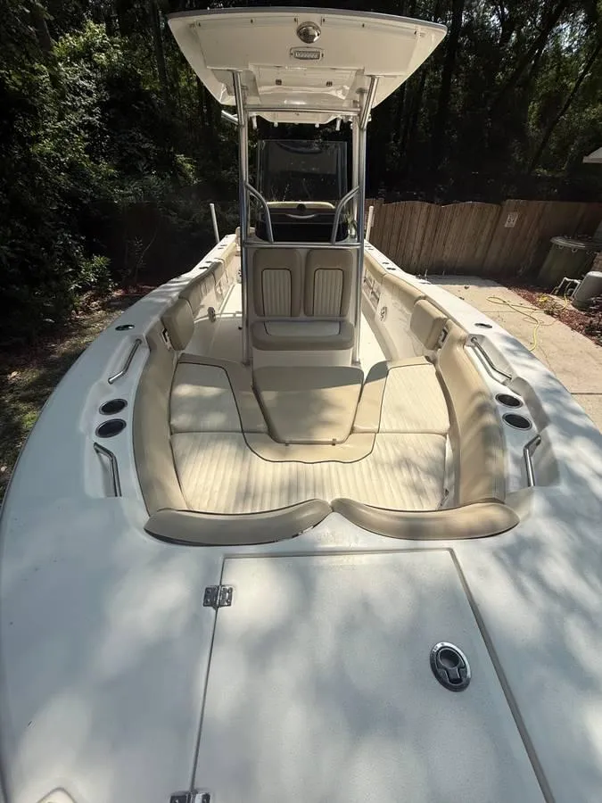 Slide: The Image of 2018 Sea Fox 248 Commander boat interior with seating and console, parked outdoors. - 12