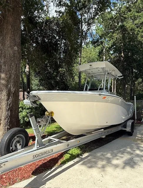 Slide: The Image of 2018 Sea Fox 248 Commander boat on trailer, surrounded by trees. - 2