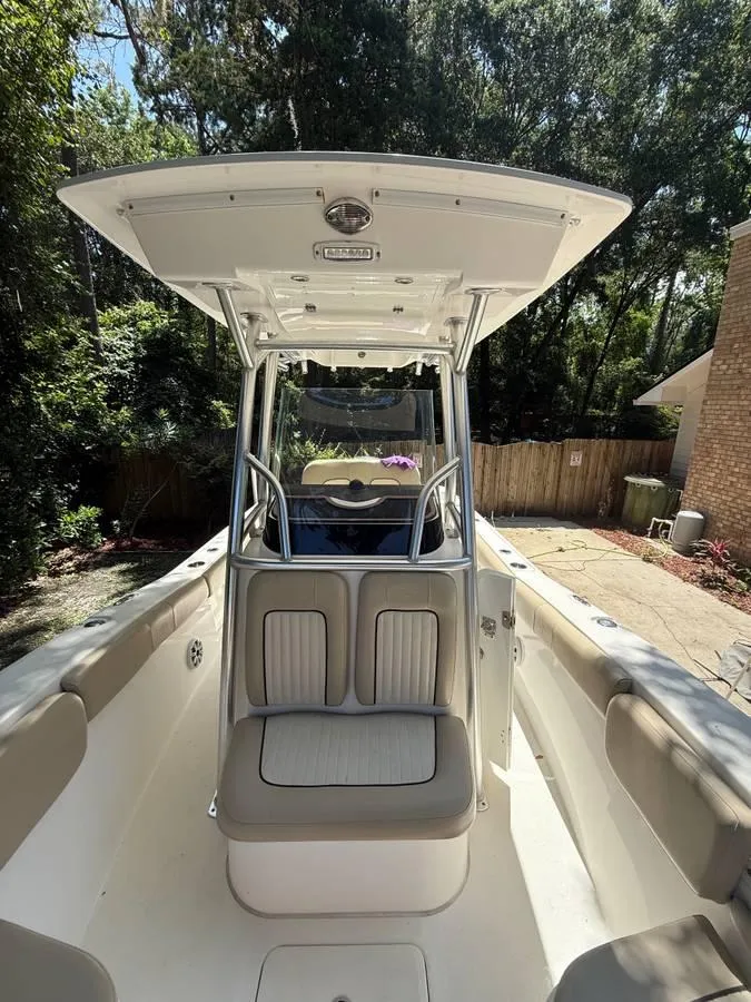 Slide: The Image of 2018 Sea Fox 248 Commander boat interior with seating and canopy, parked outdoors. - 5