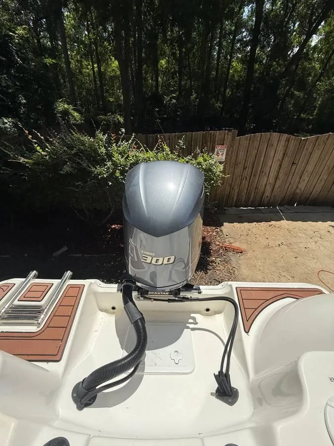 Slide: The Image of 2018 Sea Fox 248 Commander boat with Yamaha 300 outboard motor, docked near a wooden fence. - 8