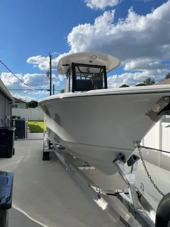 Slide: The Image of 2023 Sea Hunt Ultra 265 SE boat on trailer under a blue sky. - 1