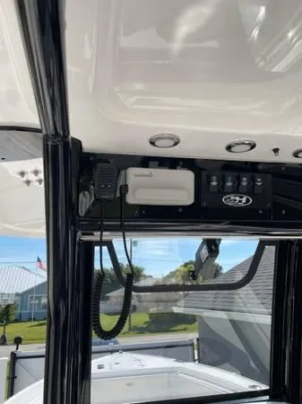 Slide: The Image of 2023 Sea Hunt Ultra 265 SE boat console with radio and controls. - 10