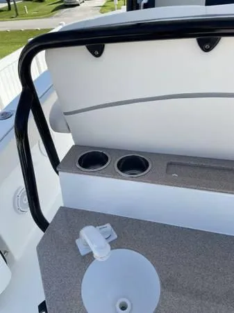 Slide: The Image of 2023 Sea Hunt Ultra 265 SE boat interior with cup holders and sink. - 12