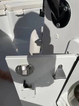 Slide: The Image of 2023 Sea Hunt Ultra 265 SE boat interior detail with latch and shadow. - 14