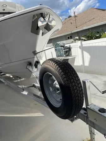 Slide: The Image of 2023 Sea Hunt Ultra 265 SE boat on trailer, close-up of bow and wheel. - 3