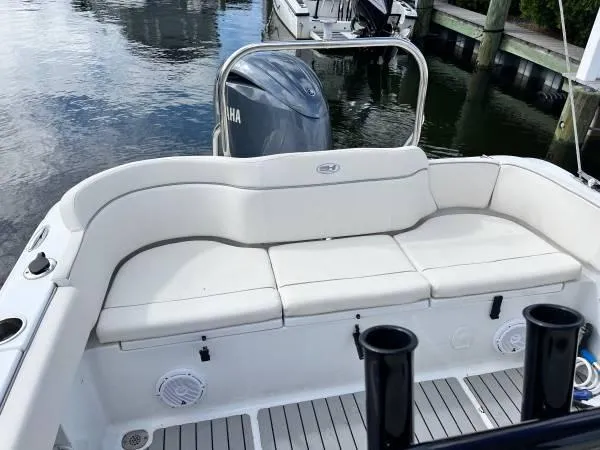 Slide: The Image of 2023 Sea Hunt Ultra 234 boat with white seating and Yamaha engine at dock. - 4