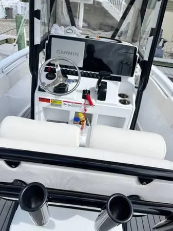 Slide: The Image of 2023 Sea Hunt Ultra 234 boat dashboard with Garmin navigation system and steering wheel. - 5