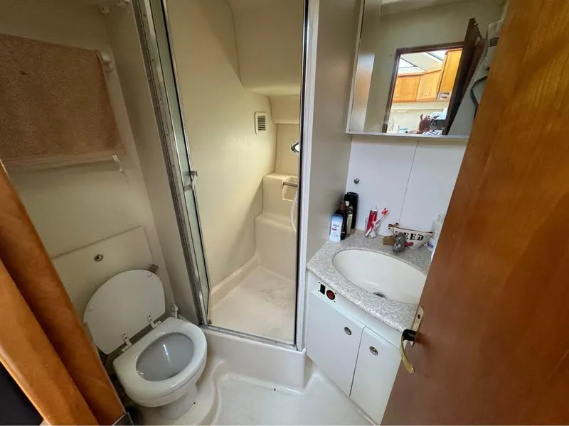 Slide: The Image of Bathroom interior of 2001 Silverton 351 Sedan Cruiser with shower, sink, and toilet. - 10