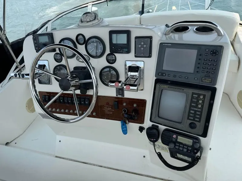 Slide: The Image of 2001 Silverton 351 Sedan Cruiser helm with steering wheel and navigation instruments. - 15