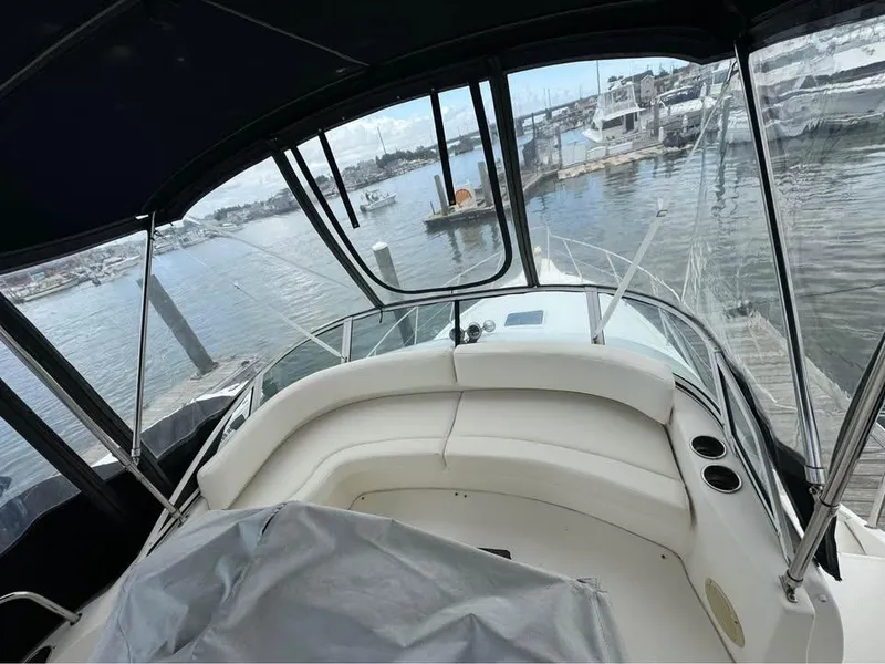 Slide: The Image of 2001 Silverton 351 Sedan Cruiser interior view at marina, showcasing seating and water surroundings. - 18
